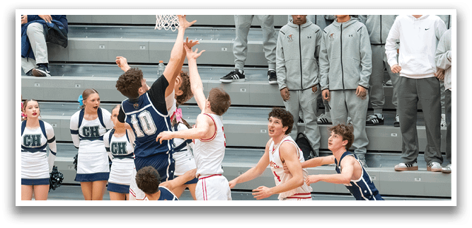 A basketball game is taking place with players on the court. One player is jumping to grab the ball while others watch. The crowd is watching the game from the stands. AI generated content