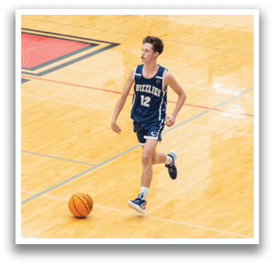 A man wearing a blue and white basketball uniform is running on a basketball court. He is holding a basketball in his hand. AI generated content