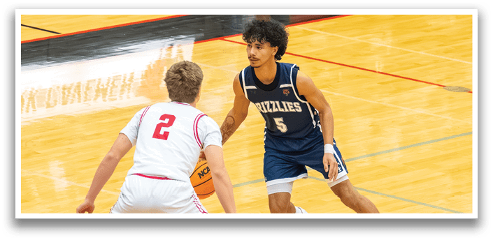 Two men playing basketball on a court. One man is wearing a blue shirt and white shorts, while the other is wearing a red shirt and white shorts. The man in the blue shirt is holding a basketball. AI generated content