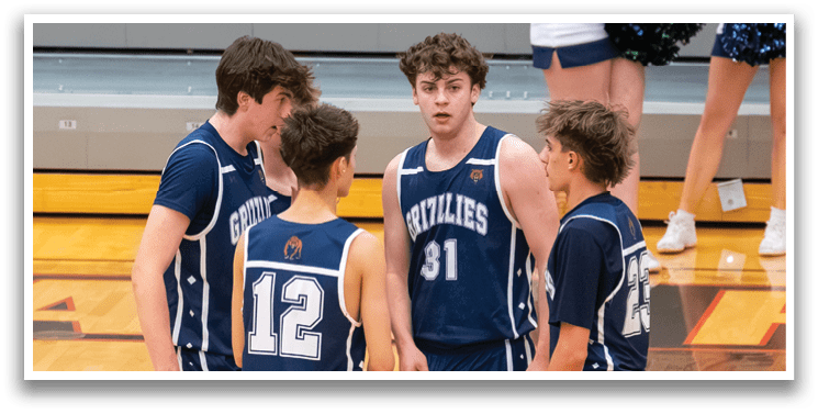 A group of young men wearing blue uniforms are standing on a basketball court, engaged in conversation. AI generated content
