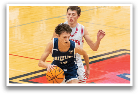 Two boys playing basketball, one holding a basketball. AI generated content