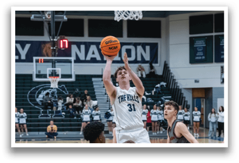 A basketball player leaps to block a shot, while other players look on. AI generated content