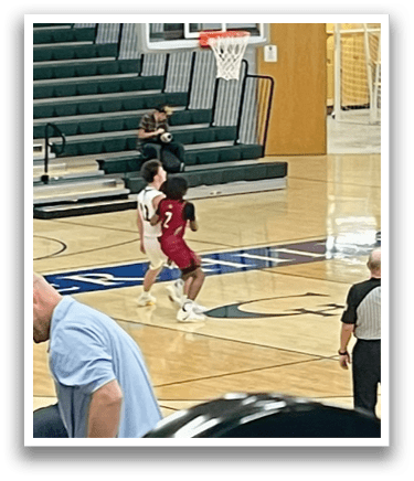 A group of people are playing basketball in a gym. AI generated content