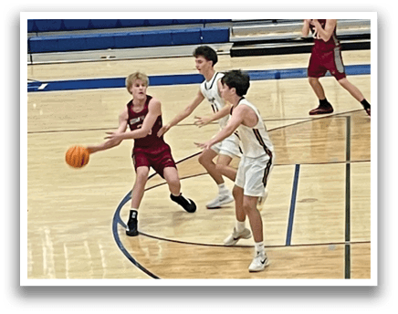 A group of young men playing basketball on a court. AI generated content