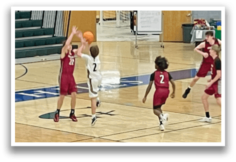A group of young men playing basketball on a court. AI generated content