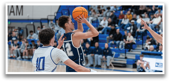 Two basketball players are competing for the ball. One player is jumping in the air to grab the ball while the other player tries to block him. The scene is taking place on a basketball court with a crowd of people watching the game. AI generated content