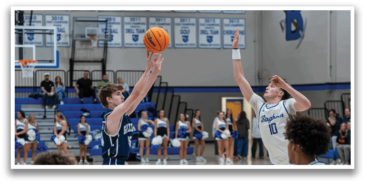 A basketball player leaps in the air to grab the ball, while a teammate watches. AI generated content