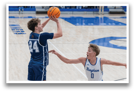 Two basketball players are on the court, one is reaching for the ball while the other is trying to block him. AI generated content