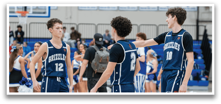 A group of young men wearing blue uniforms are standing on a basketball court. AI generated content