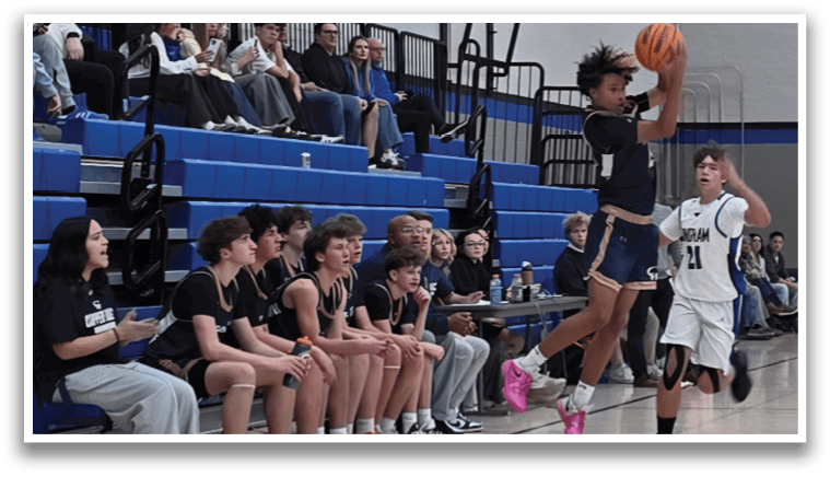 A basketball game is taking place with a player in the air trying to get the ball. The crowd is watching the game intently. AI generated content