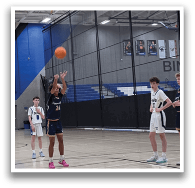 A group of young men playing basketball on a court. AI generated content