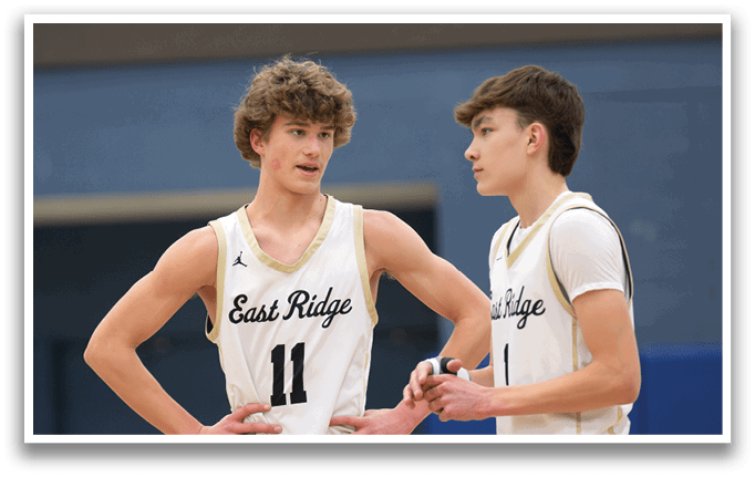 Three male athletes wearing East Ridge jerseys are standing together on a basketball court. AI generated content