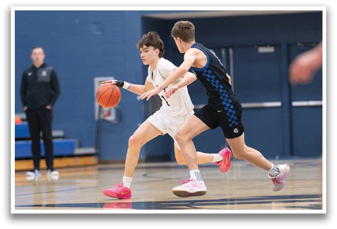Two basketball players are running for the ball, one wearing a white shirt and the other wearing a black shirt. AI generated content