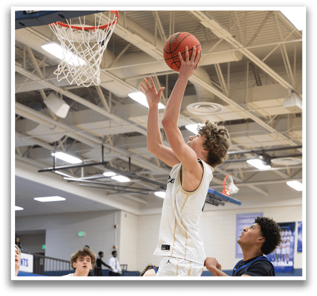 A basketball player is jumping to block a shot, while other players watch from the sidelines. AI generated content