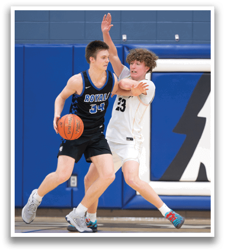 Two basketball players on a court, one with a ball and the other trying to block him. AI generated content