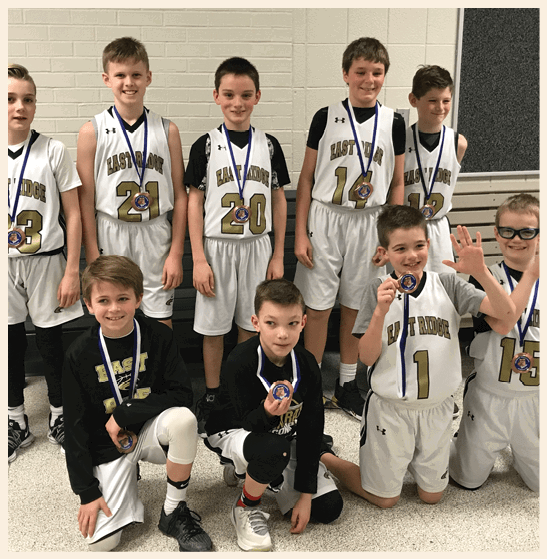 A group of young boys wearing basketball jerseys and holding trophies. AI generated content