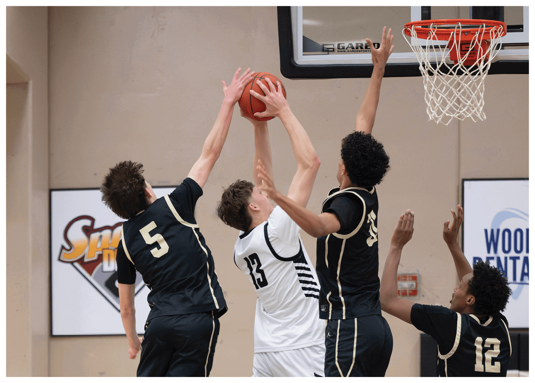 Four basketball players are leaping for the ball. AI generated content