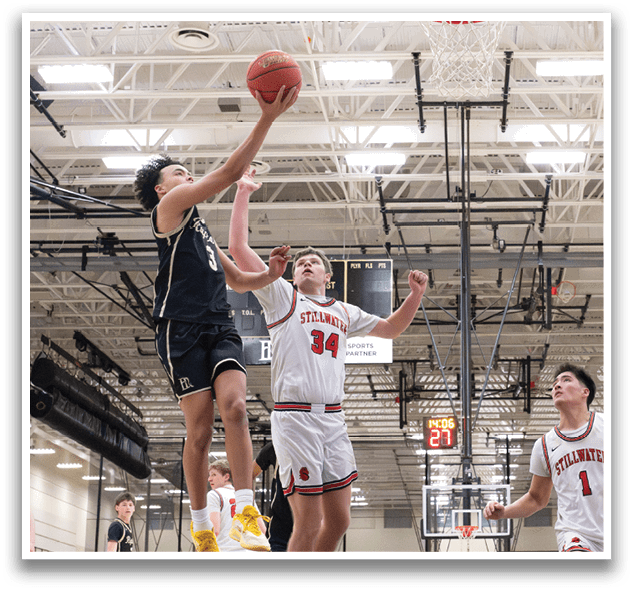 Basketball players in action on a court, one player leaps to block a shot. AI generated content