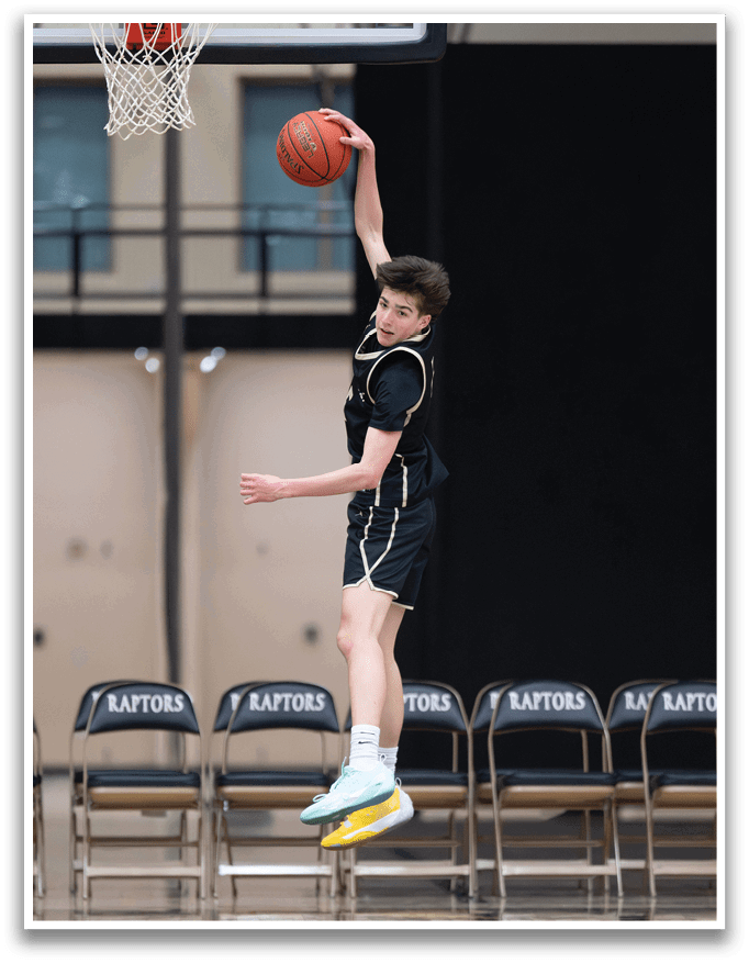A boy is jumping in the air to catch a basketball. AI generated content
