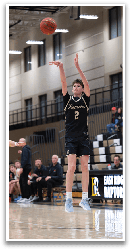 A basketball player in a black and gold uniform leaps to catch a basketball. AI generated content