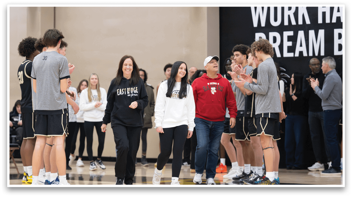 A group of people, including a man in a red shirt, are standing on a basketball court. AI generated content