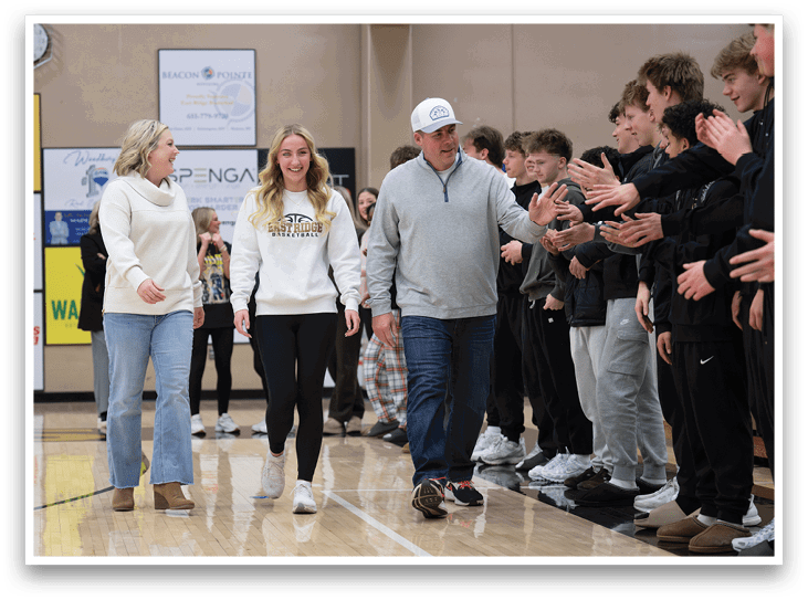 A man and woman are walking on a basketball court, surrounded by a crowd of people. AI generated content