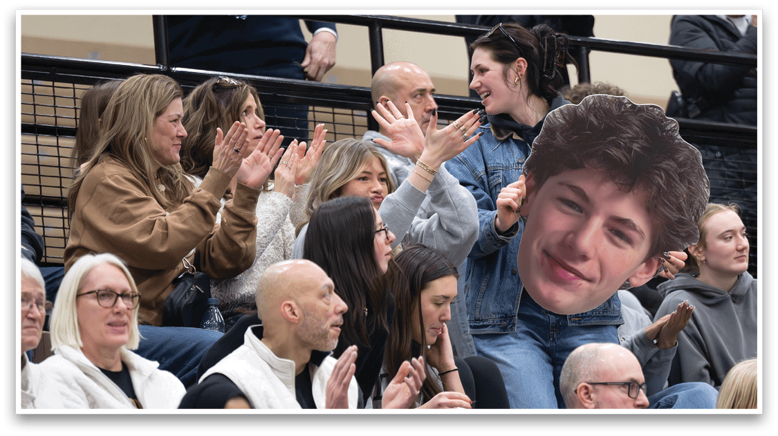 A man with a head cutout of another man is sitting in the audience. AI generated content