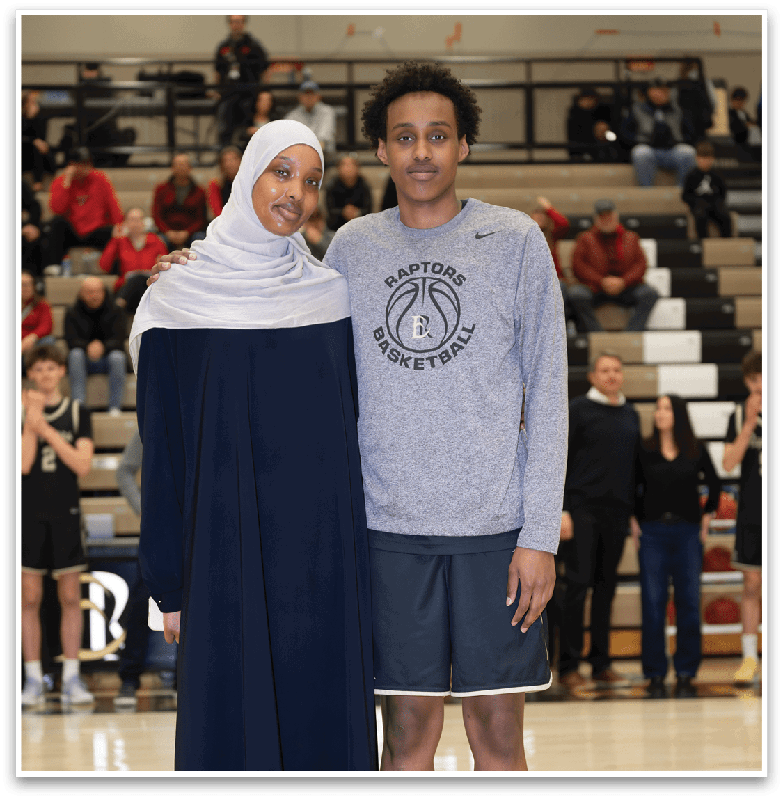 A man and woman pose for a picture on a basketball court. AI generated content