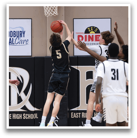 A basketball player jumps to block a shot, while another player tries to score. AI generated content