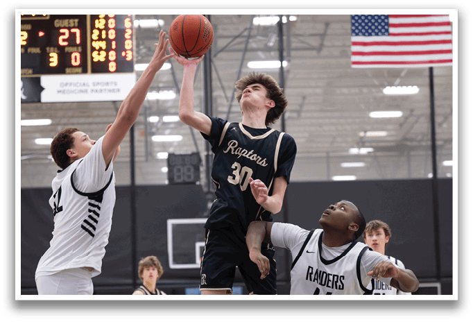 A basketball player jumps to block a shot, while the other players on the court watch. AI generated content
