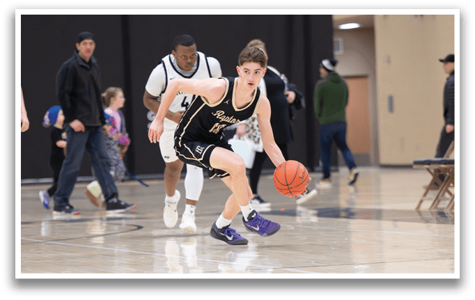 A basketball player wearing a black and gold uniform is running with a basketball in his hand. AI generated content