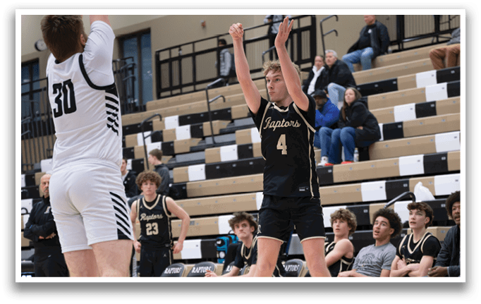 A basketball game is taking place with a player in the air attempting to block a shot. AI generated content