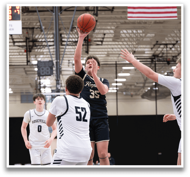 A basketball player is jumping to block a shot, while another player attempts to shoot the ball. AI generated content