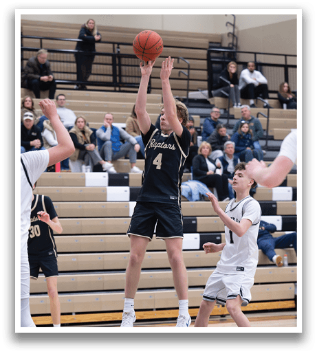 A basketball player leaps into the air to grab the ball, while other players look on. AI generated content