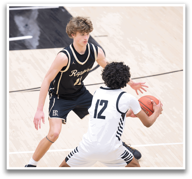 Two basketball players on a court, one with the number 12 on his shirt, the other with the number 14. AI generated content