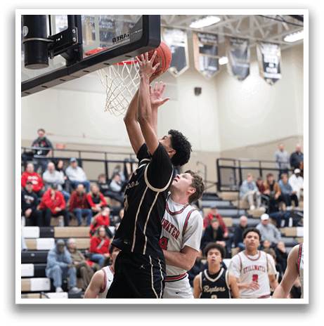Basketball players on a court, one of them jumping to block a shot. AI generated content