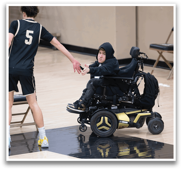 A man in a wheelchair shakes hands with another man on a basketball court. AI generated content