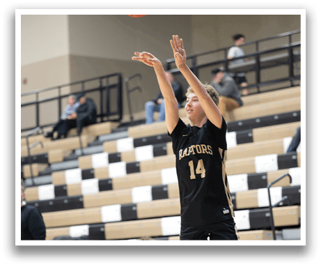 A basketball player in a black and gold uniform is jumping to shoot a basketball. AI generated content