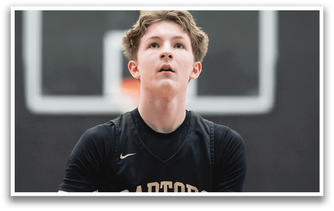 A basketball player wearing a black jersey with the word “Toronto" on it holds a basketball in his hands. AI generated content