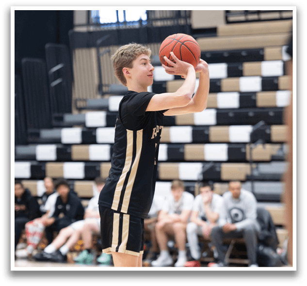 A basketball player in a black and gold uniform is jumping up to catch a basketball. AI generated content
