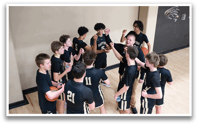 A group of young men wearing basketball uniforms are huddled together on a basketball court. AI generated content