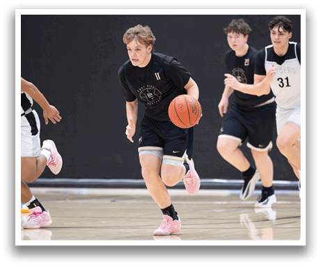 A group of young men playing basketball, one of them holding a basketball. AI generated content