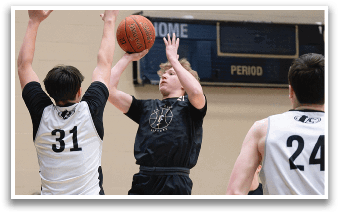 A basketball game is in progress with players on the court. One player is jumping up to grab the ball while another player is trying to block him. The players are wearing uniforms and are focused on the game. AI generated content