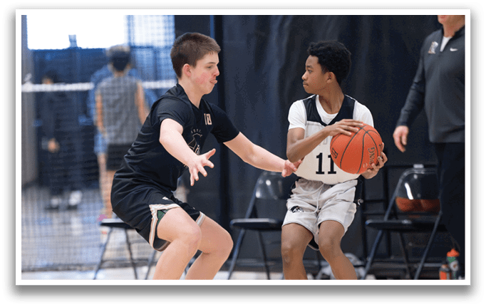 Two boys are playing basketball, one of them is trying to block the other from getting the ball. AI generated content
