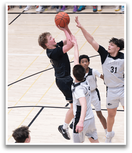 A group of young men playing basketball, with one player attempting to block a shot. AI generated content