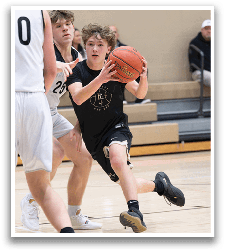 A boy in a black shirt is running with a basketball, trying to get past two other players. AI generated content
