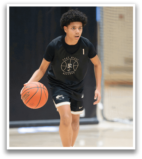 A young man wearing a black shirt and shorts is holding a basketball. AI generated content