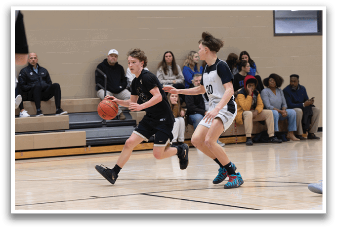 Two boys are playing basketball on a court, one holding a basketball and the other trying to block him. AI generated content