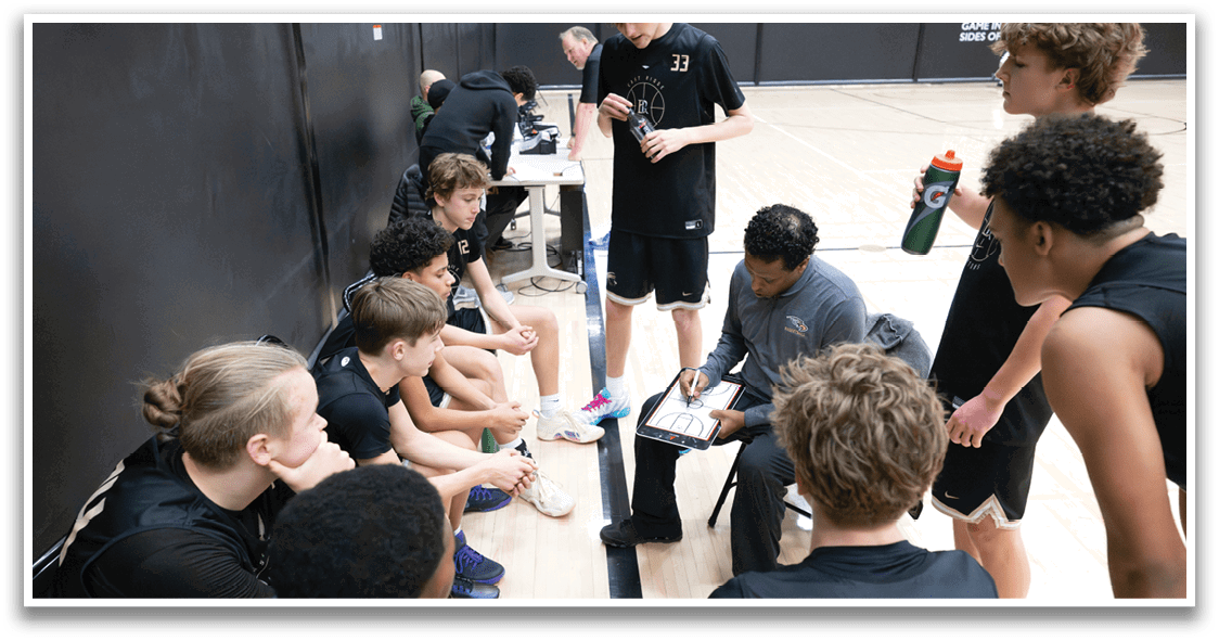 A group of young men are sitting on the floor in a gym, engaged in a conversation. AI generated content