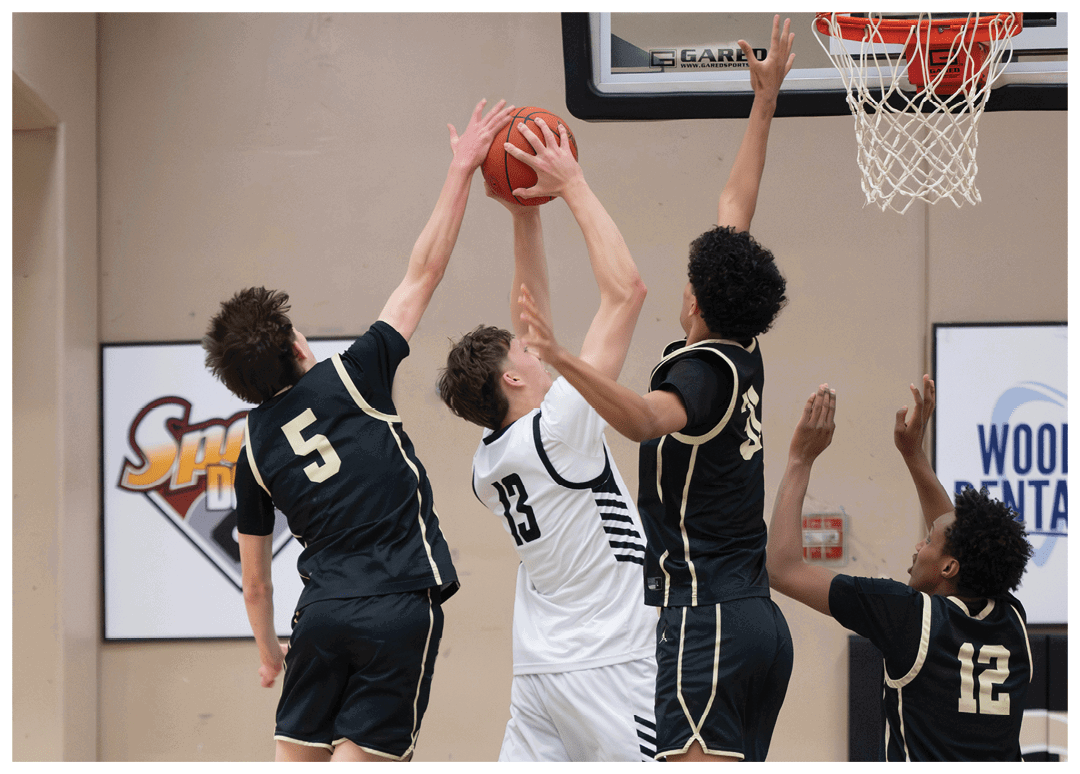 Four basketball players are leaping in the air to reach for the basketball. AI generated content